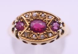 An 18 ct gold ruby and diamond ring. Ring size Q/R. 3.9 grammes total weight.