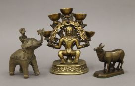 An Indian bronze deity figure and two others. The former 13 cm high.