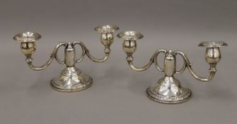 A pair of Rogers sterling silver twin branched candelabra. 11 cm high. 531.1 grammes weighted.