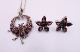 A Bohemian garnets with pearl drops pendant on a later silver chain,