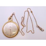 An 18 ct gold Bucherer open face pocket watch on a 9 ct gold chain. 4.25 cm diameter. The watch 38.