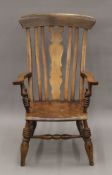 A 19th century splat back open arm chair. 62 cm wide.
