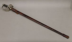 A George V Service sword in scabbard. 99 cm long.