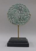 A jade bi disc on stand. 27.5 cm diameter.