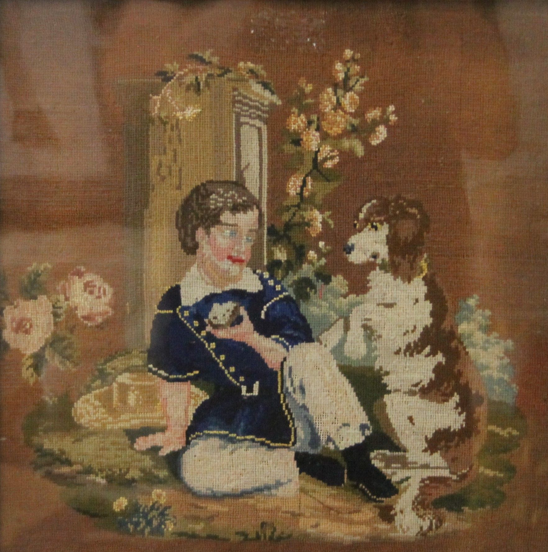 A Victorian tapestry of a boy and dog, housed in a maple frame and glazed. 36.5 x 36.5 cm overall.
