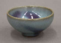 A Chinese Jun Ware purple splash bubble bowl, Song Dynasty. 6 cm diameter.
