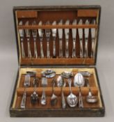 A cutlery canteen containing cutlery. 34.5 cm wide.