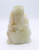 A Chinese light green jade carved figure of an old man, Qing Dynasty. 5.5 cm high.