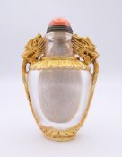 A Chinese gilded glass snuff bottle decorated with dragons. 8.5 cm high.