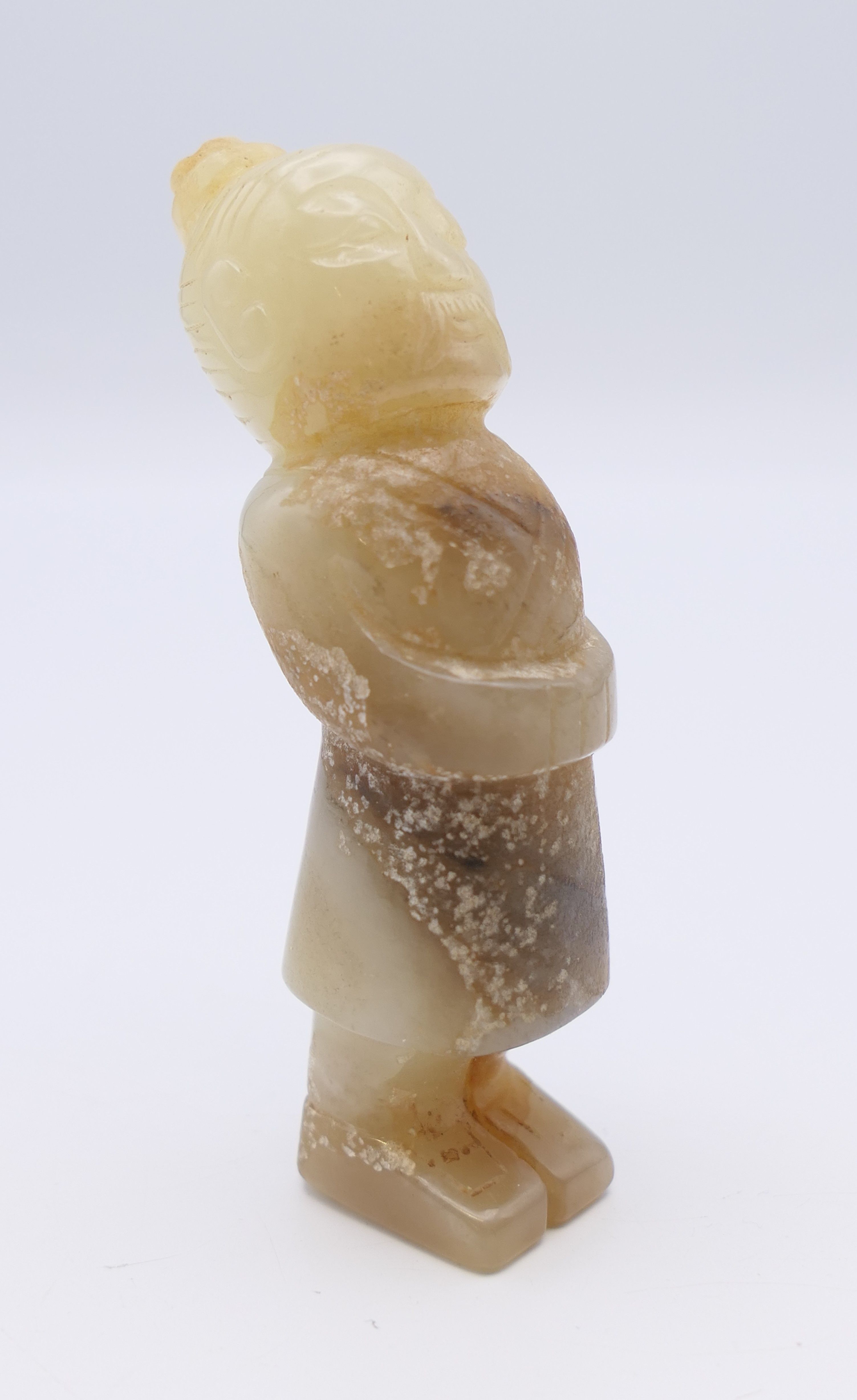 A Chinese jade standing male figure, hands clasped at waist, Han Dynasty. 7 cm high.