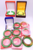 Twelve Chinese jade bangles of various colours and sizes, some boxed.