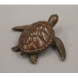 A bronze model of a turtle. 5 cm long.