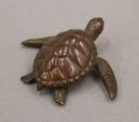 A bronze model of a turtle. 5 cm long.