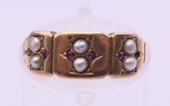 An antique 15 ct gold, seed pearl and ruby ring. Ring size L/K. 1.9 grammes total weight.
