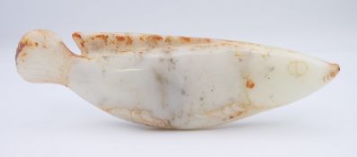 A large Chinese white jade fish, Yuan Dynasty. 19 cm long. Provenance: The Larkin/Minney Collection.