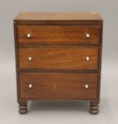 A Victorian miniature mahogany chest of drawers. 37 cm wide.
