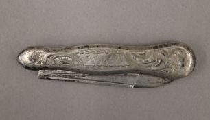 A silver penknife. 8 cm long.