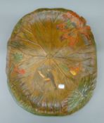 A late 19th/early 20th century polychromed wooden plaque hand carved with frogs, water lilies, etc.