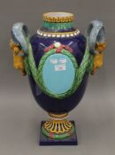 A large Majolica twin handled vase. 53 cm high.