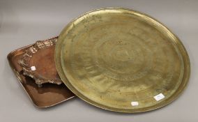 Two copper trays and a brass tray. The largest 59 cm long.