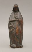An early carved wooden religious figure. 21 cm high.