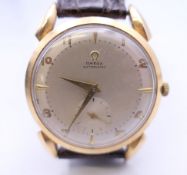 A 9 ct gold Omega gentleman's wristwatch. 3.5 cm wide. 34.8 grammes total weight.