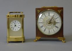 A carriage clock and a mantle clock. The former 15 cm high.
