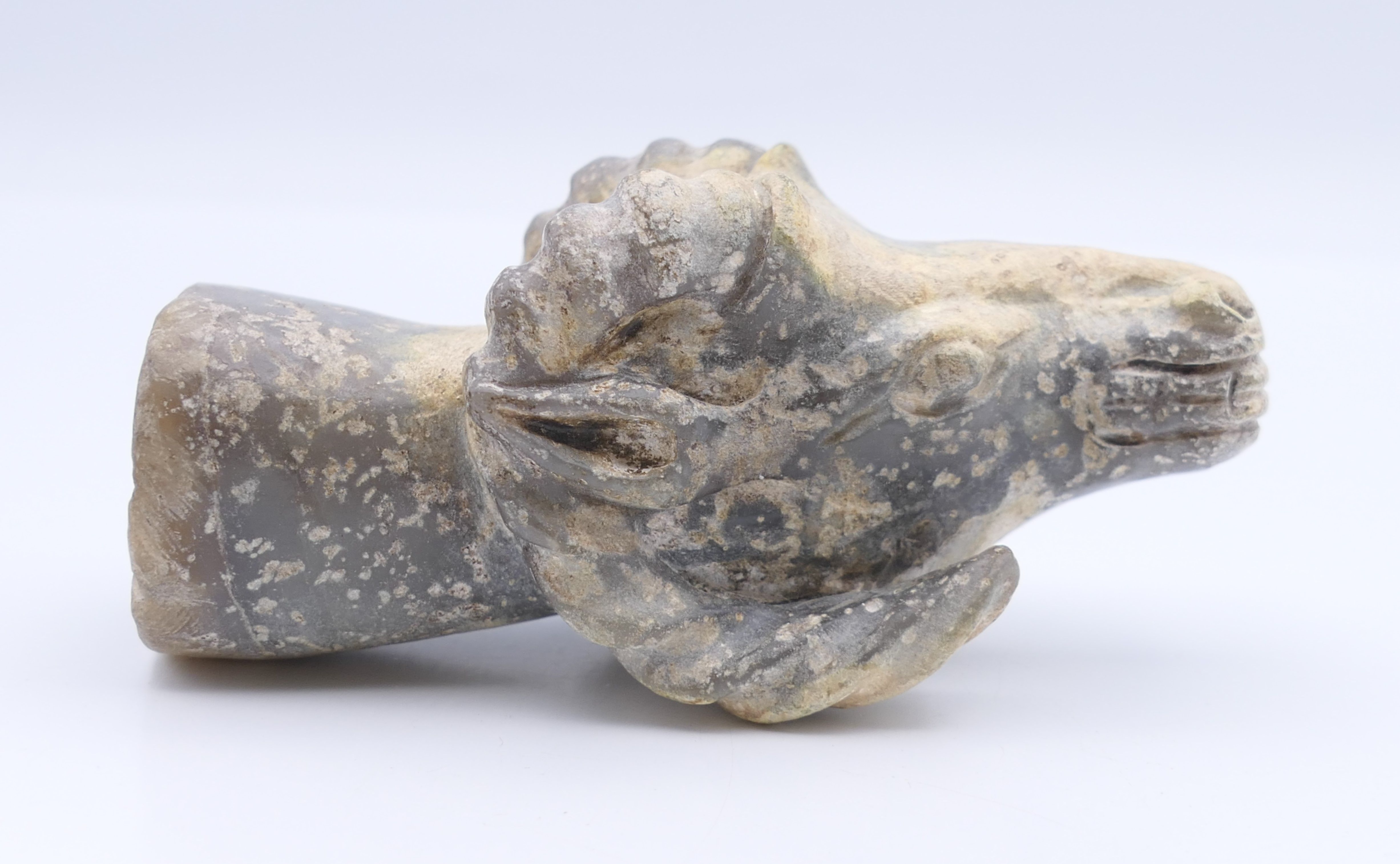 A Chinese white and grey jade rams head, Han Dynasty. 9.5 cm long.