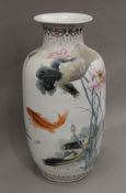 A large Chinese porcelain vase decorated with fish. 59 cm high.
