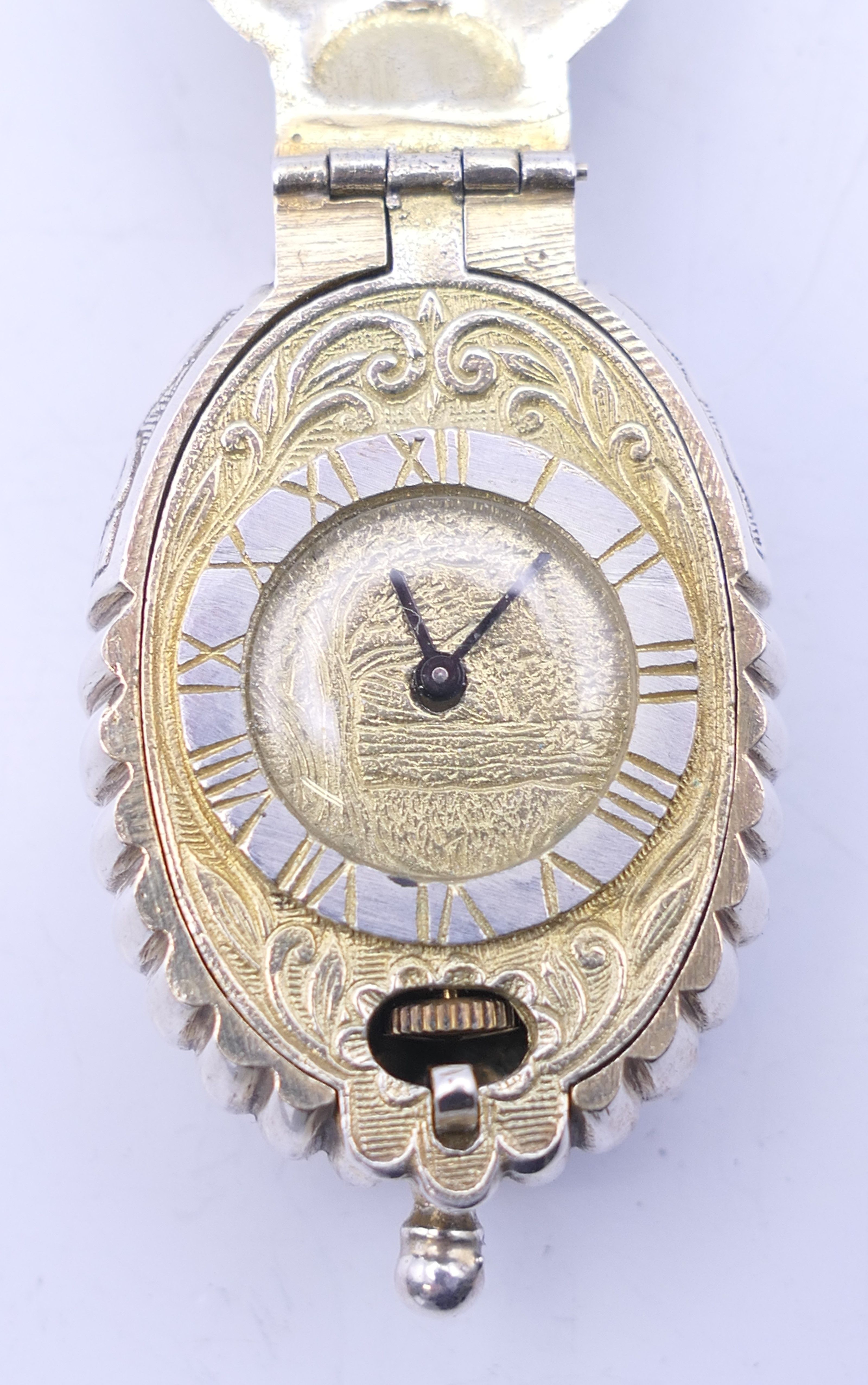 A fob watch formed as a shell, with lion and panther hallmarks, numbered 301/2500. 5 cm high.