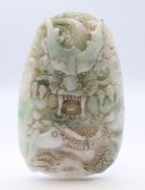 A Chinese light green and white jade dragon pendant, Qing Dynasty. 8 cm high.