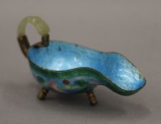 A Chinese enamelled drinking cup with jade handle. 10 cm long.