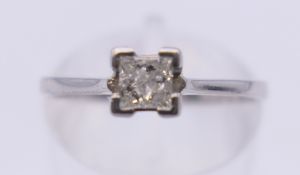 A platinum princess cut diamond solitaire ring. Ring size M. 3.2 grammes total weight.