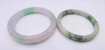 Two jade bangles. Each approximately 5 cm interior diameter.
