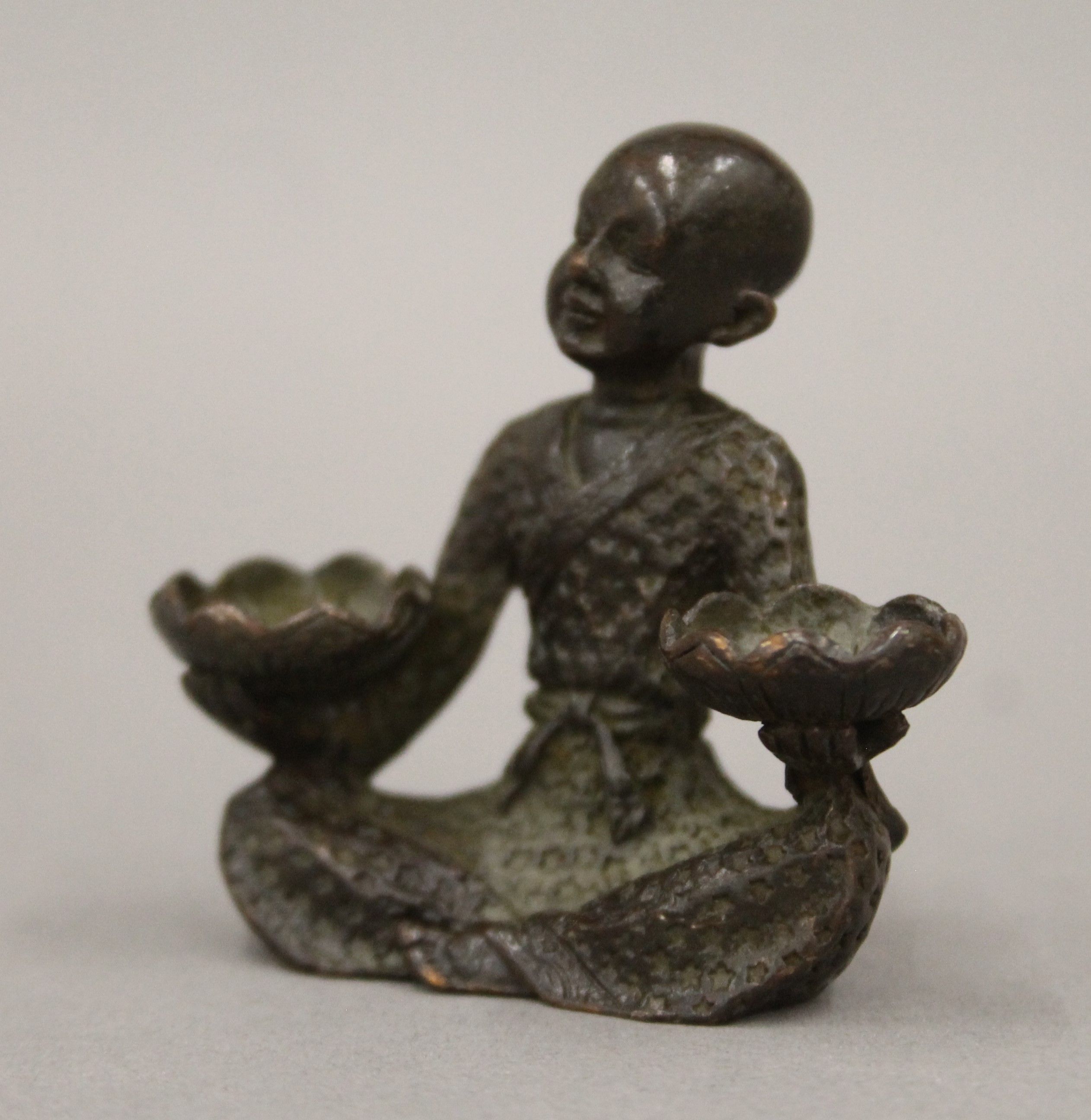 A bronze model of a boy with lilies. 5.5 cm high. - Image 3 of 6