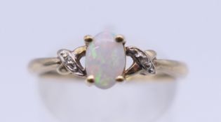 A 10 K gold opal and diamond ring. Ring size N/O. 1.4 grammes total weight.