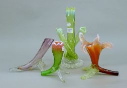 Four coloured glass bud vases. The largest 25 cm high.