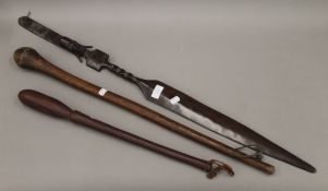 Two tribal clubs and a tribal staff. The latter 97 cm long.