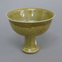 A Chinese celadon stem cup. 11 cm high.