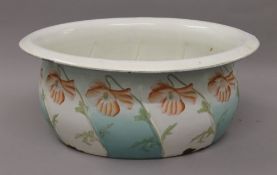 A French enamel jardiniere decorated with flowers. 46 cm long.