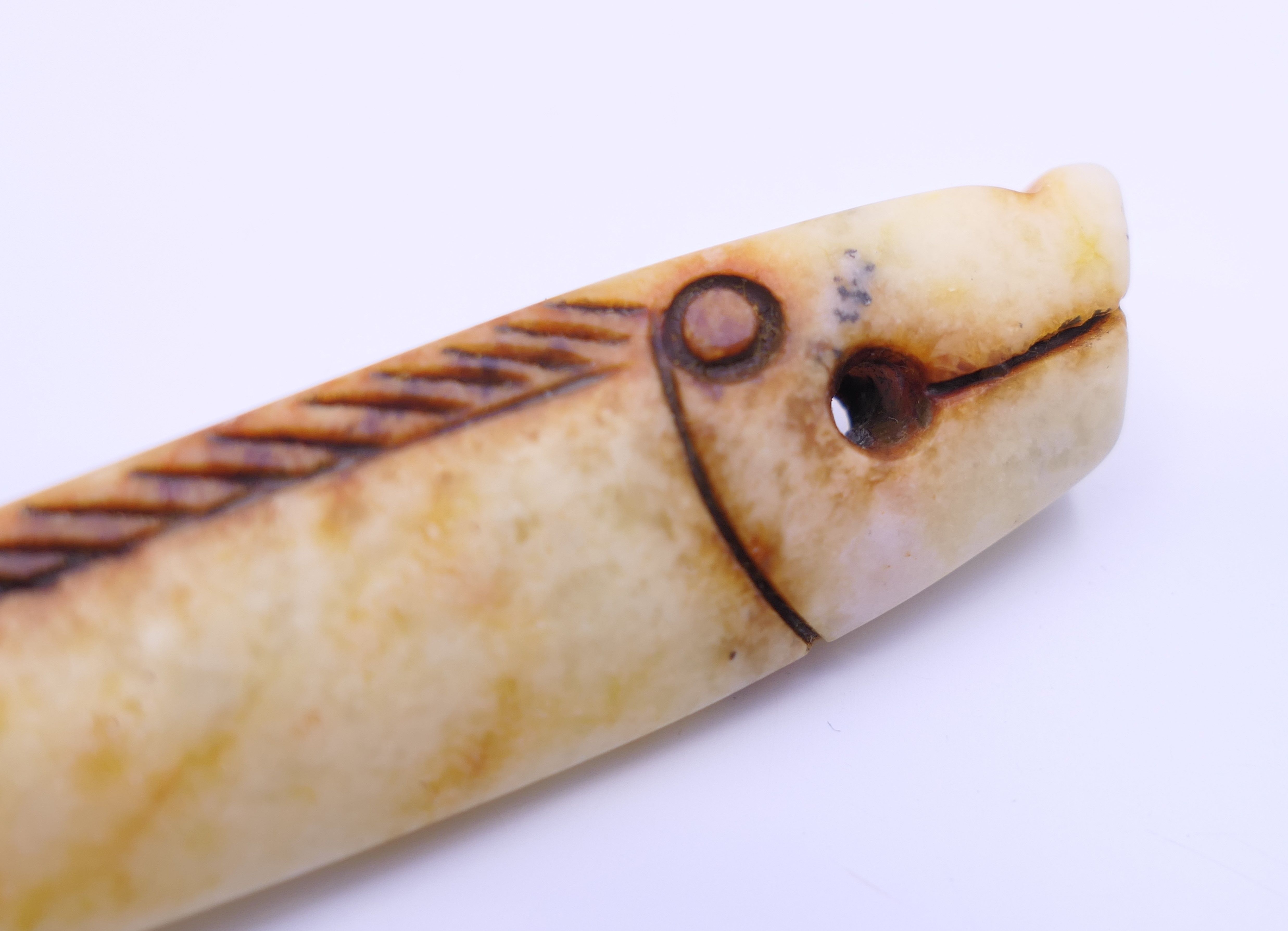 A small Chinese russet jade coloured fish, Shang Dynasty. 7.5 cm long. - Image 3 of 4