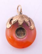 A Chinese gold mounted circular agate pendant. 2.25 cm diameter.