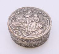 A embossed Continental silver box. 5 cm diameter. 44.3 grammes.