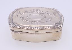 An embossed silver jewellery box. 10 cm wide.