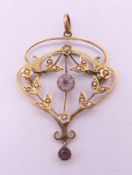 A 9 ct gold Art Nouveau pendant. 3 cm high. 2.4 grammes total weight.