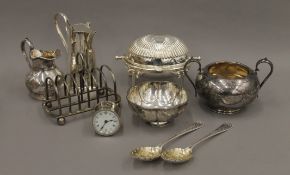 A small quantity of silver plate and a small alarm clock.