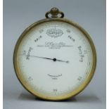 A cased Victorian pocket barometer by L Casella. 7.25 cm diameter.