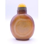 A large Chinese brown agate snuff bottle, with yellow stopper. 7.5 cm high.