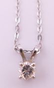 A white gold diamond pendant on a 9 ct white gold chain. The pendant 8 mm high.