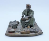 An Austrian cold painted bronze model of an Arab cobbler. 5.25 cm high.